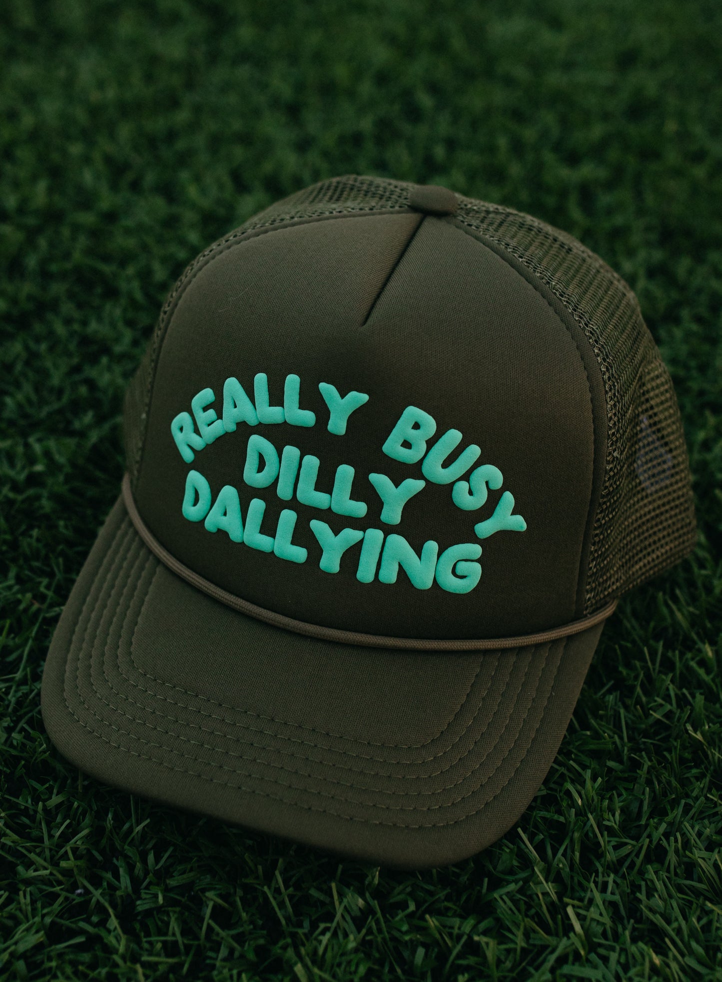 Really Busy Dilly Dallying Trucker Hat in Olive/Mint