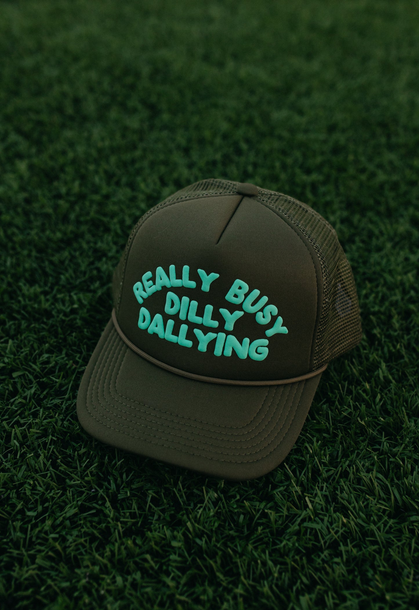 Really Busy Dilly Dallying Trucker Hat in Olive/Mint