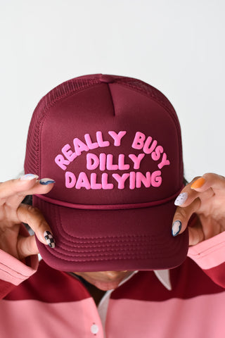 Really Busy Dilly Dallying Trucker Hat in Burgundy/Pink