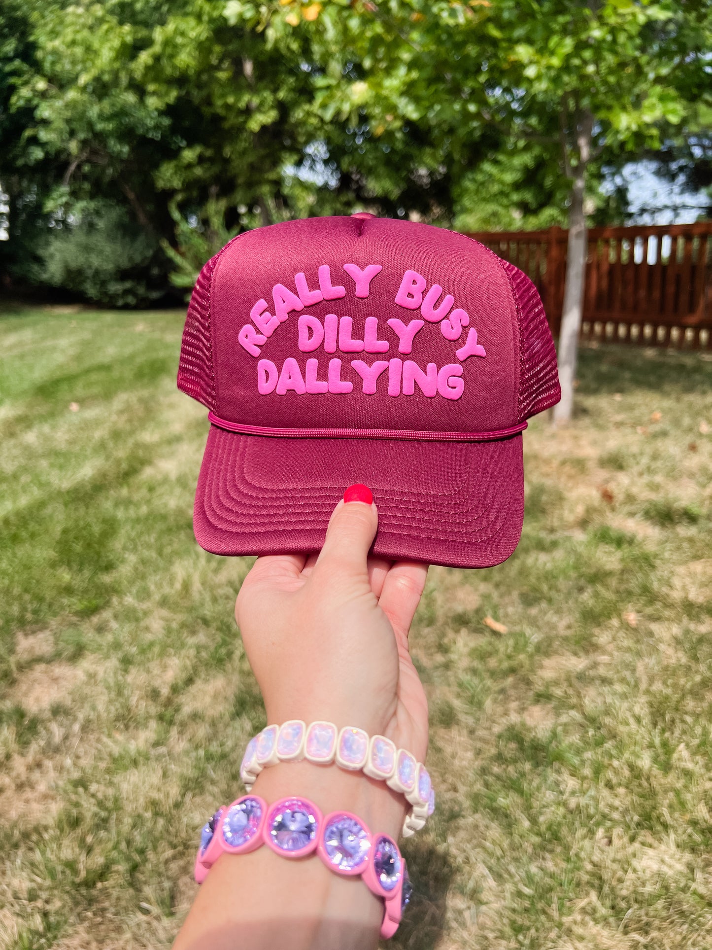 Really Busy Dilly Dallying Trucker Hat in Burgundy/Pink