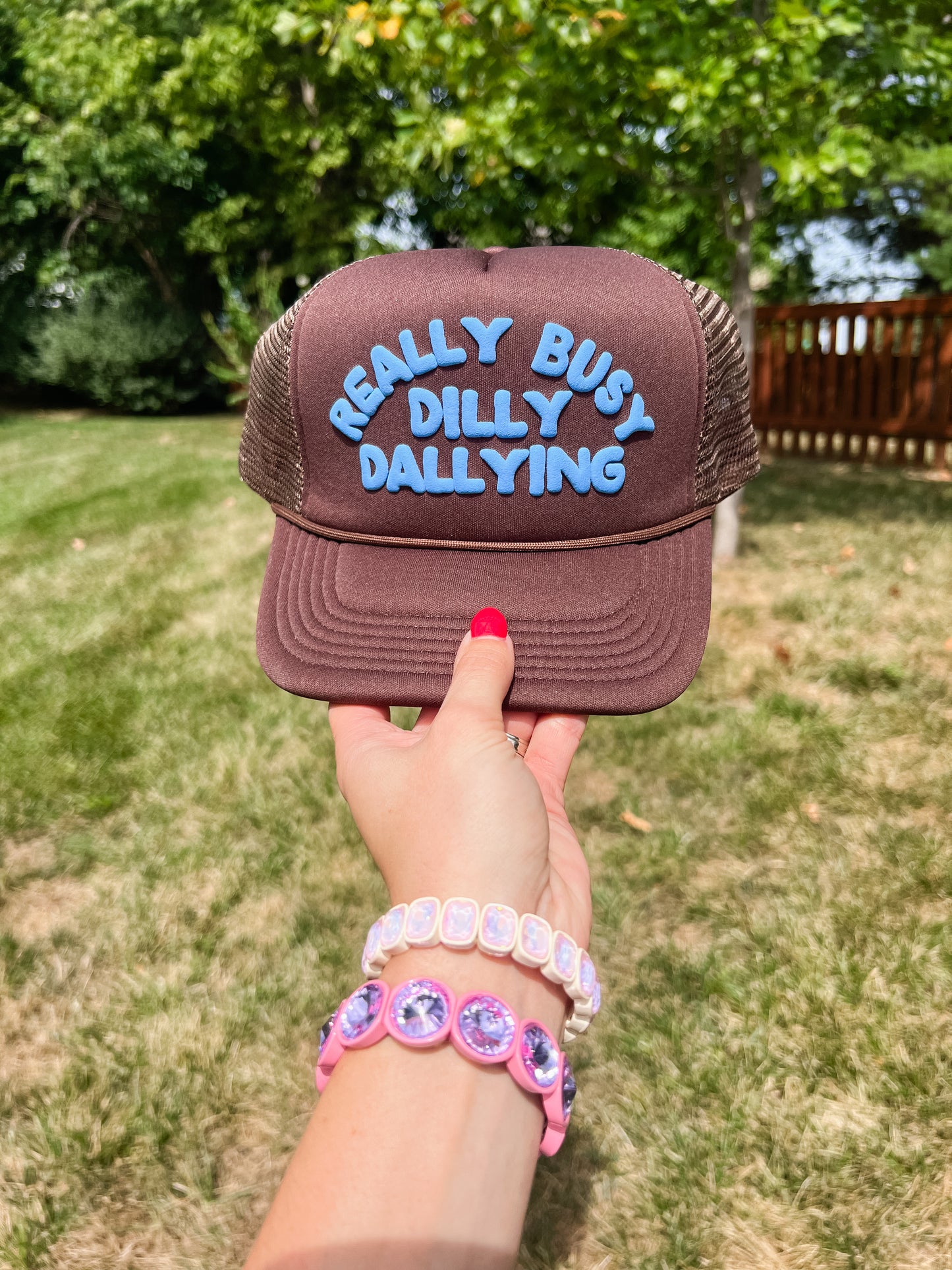Really Busy Dilly Dallying Trucker Hat in Brown/Blue