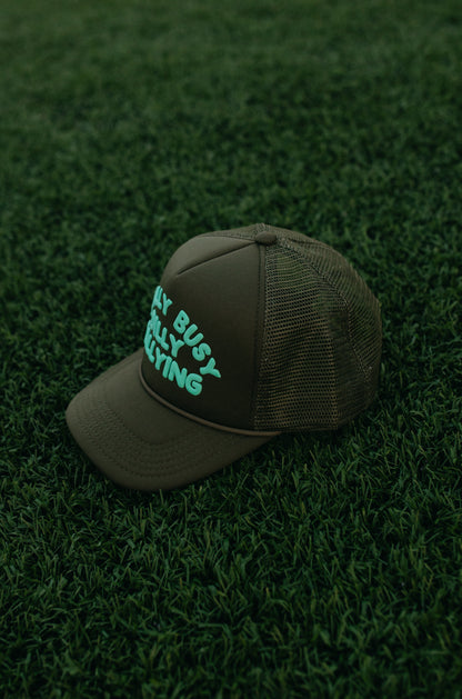 Really Busy Dilly Dallying Trucker Hat in Olive/Mint