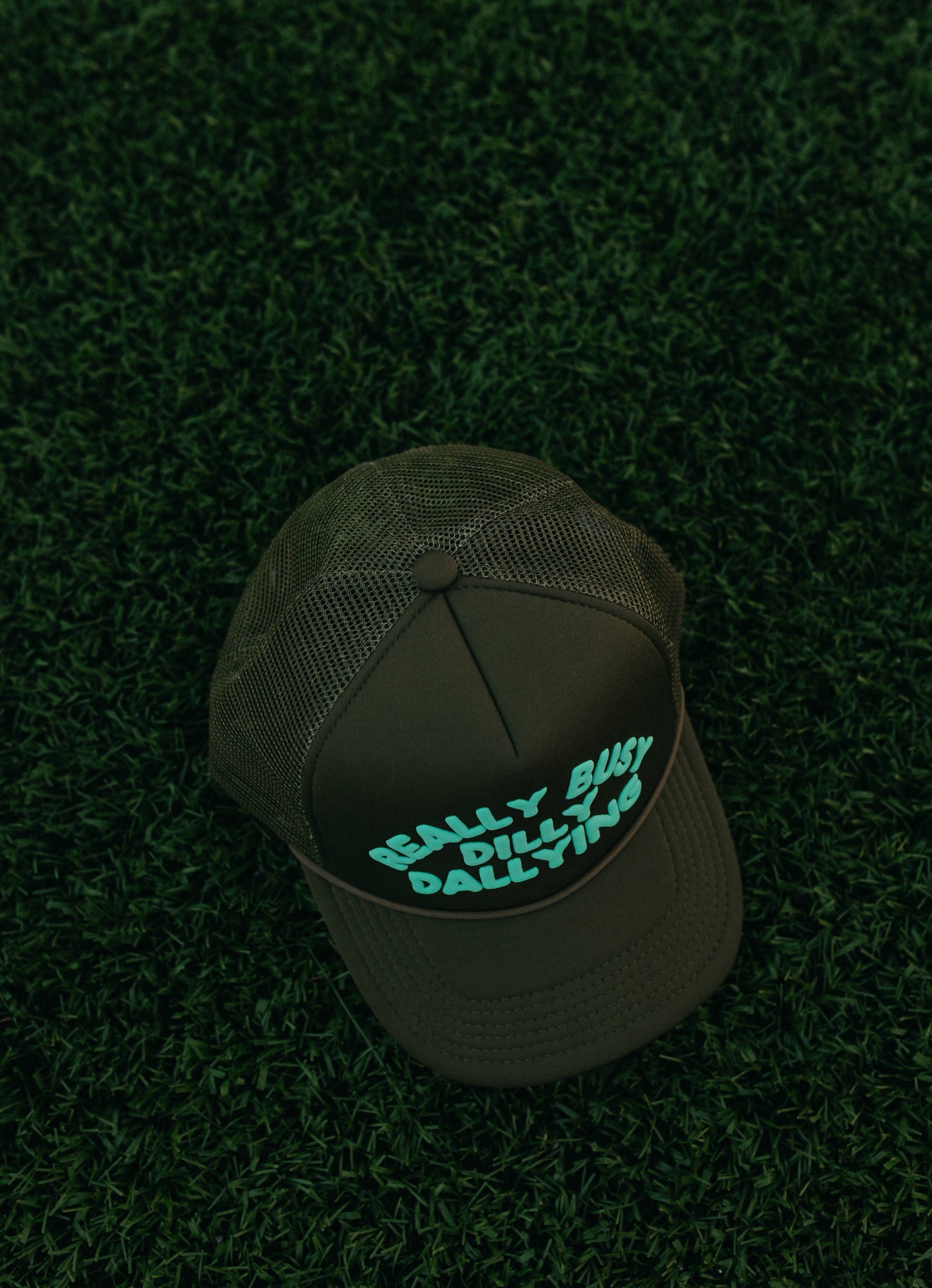 Really Busy Dilly Dallying Trucker Hat in Olive/Mint