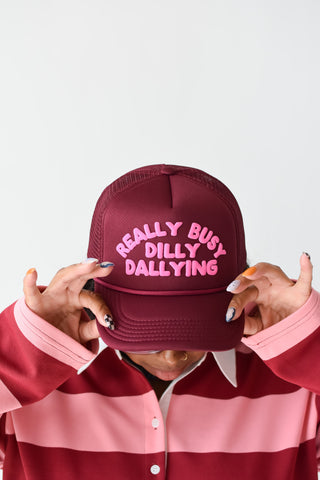 Really Busy Dilly Dallying Trucker Hat in Burgundy/Pink